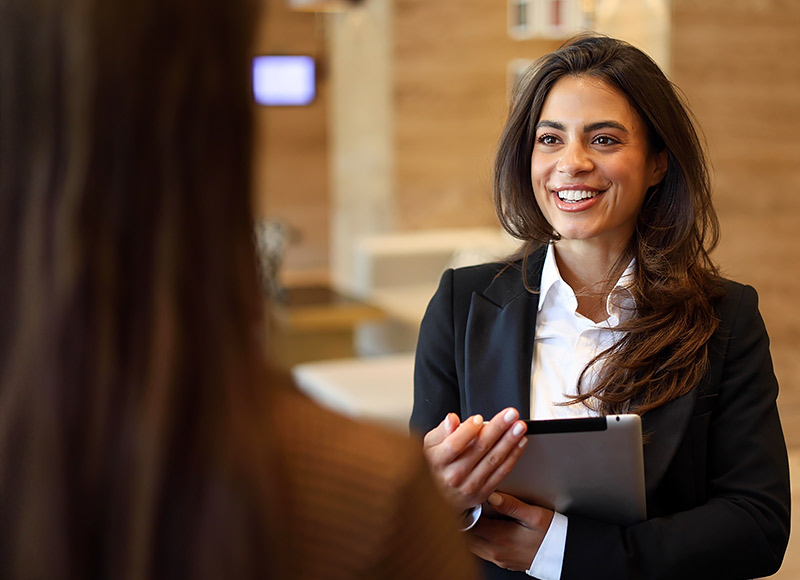 Professional businesswomen discussing about culture of paradise collection